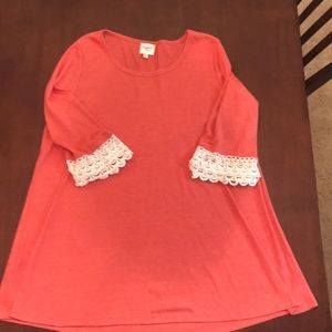 Orange tunic with lace detail on sleeves